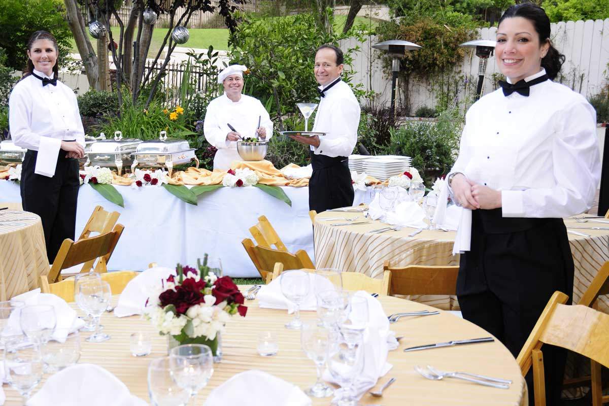 Wedding services team setting up a reception