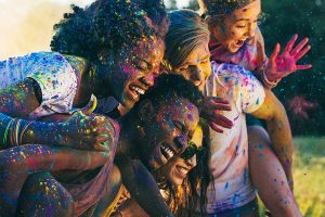 multicultural-happy-friends-piggybacking-together-AJSCTG4